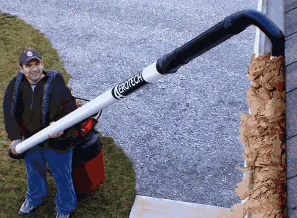 Man cleaning gutters with Aerotech vacuum system.