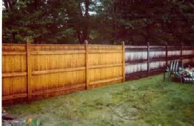 Pressure washing fence cleaning half of wooden fence clean other half not.